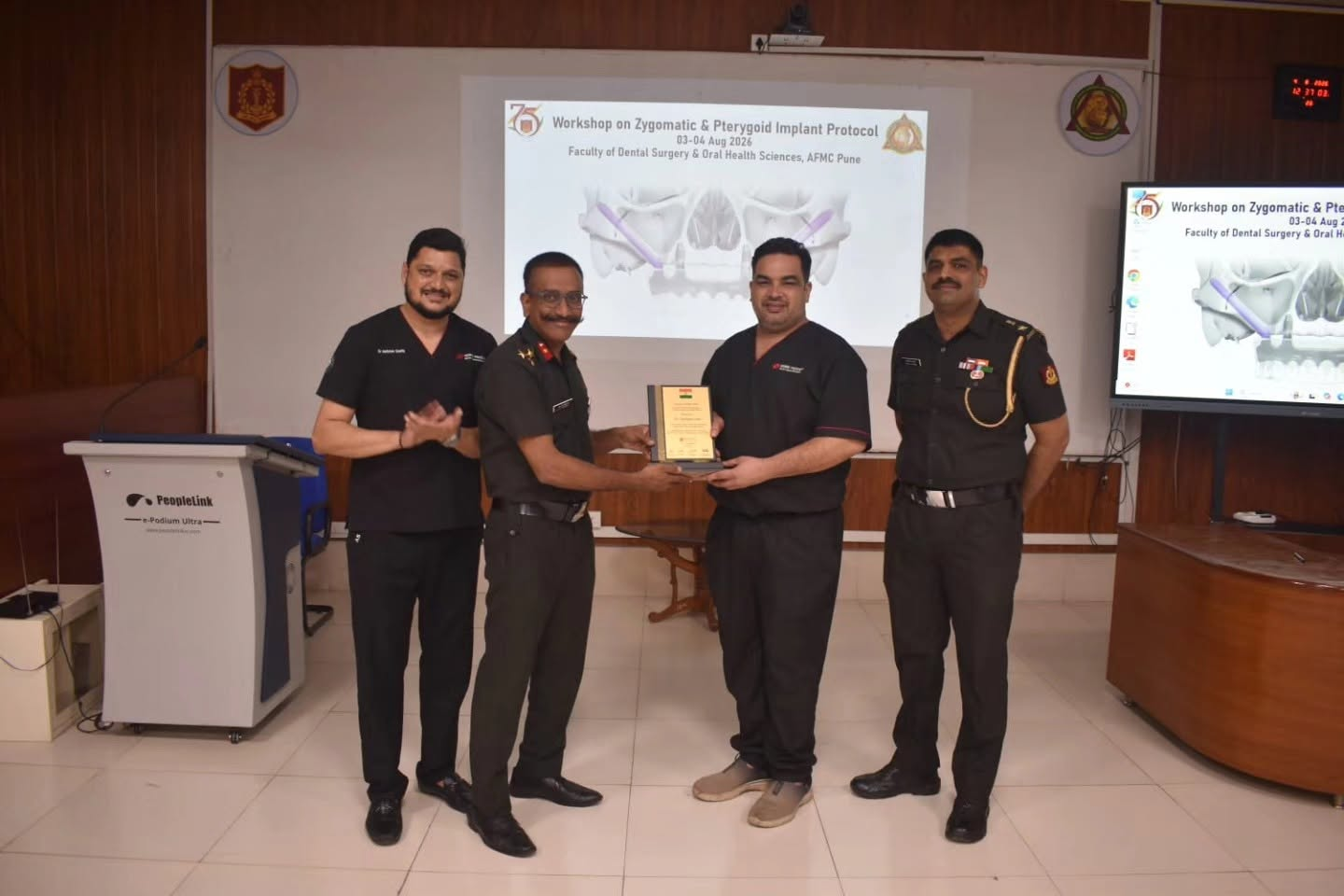 Dr. Vijaykumar Girhe receiving a memento from Army Medical Corps officers after conducting an advanced implant workshop at AFMC Pune